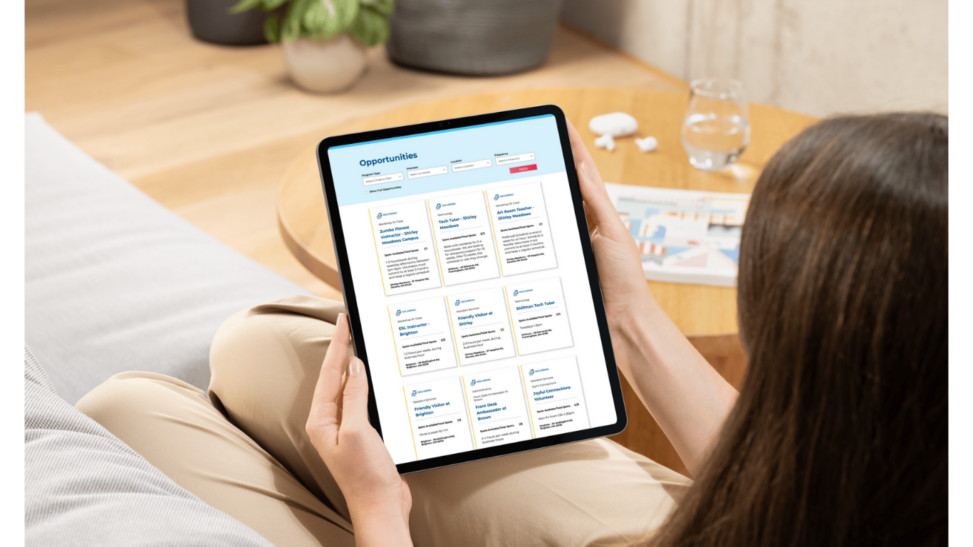 A person looking at the 2Life Volunteer Portal on a tablet device