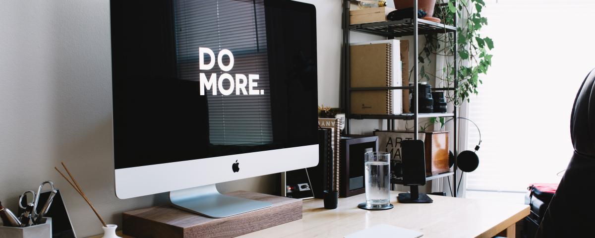 A photo of a silver iMac with keyboard and trackpad inside room. Photo by Carl Heyerdahl on Unsplash