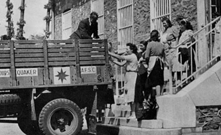 Monochrome image of people getting into the back of a truck