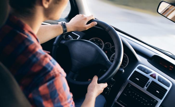 Image of driver behind the wheel of an electric vehicle